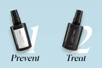 Angled view of two KilgourMD scalp serums: left 'Prevent' (white bottle, 1) and right 'Treat' (black bottle, 2) on pale blue background