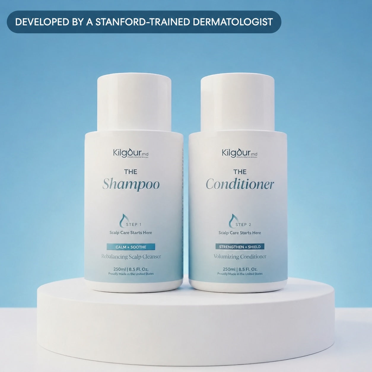 Two white bottles of KilgourMD hair care products, labeled 'The Shampoo' and 'The Conditioner', displayed side-by-side on a white pedestal against a light blue background with a dark blue banner at the top.