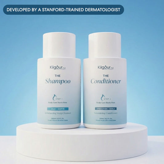 Front view of KilgourMD shampoo and conditioner bundle showing two white bottles with blue labels on a light blue background